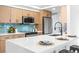 Bright kitchen with a modern island, stainless steel appliances, and eye-catching blue backsplash at 2484 E 101St Ct, Thornton, CO 80229