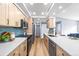 Bright kitchen featuring stainless appliances, light wood cabinets, and tile backsplash at 2484 E 101St Ct, Thornton, CO 80229