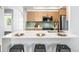Open kitchen with counter seating and a sleek design that is perfect for entertaining at 2484 E 101St Ct, Thornton, CO 80229