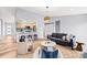 Open-concept living area with adjacent kitchen, stylish furnishings, and lots of natural light at 2484 E 101St Ct, Thornton, CO 80229