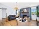 Inviting living room featuring a gray brick fireplace, comfortable seating, and a stylish area rug at 2484 E 101St Ct, Thornton, CO 80229