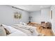 Spacious bedroom with natural light, hardwood floors, and a cozy seating area at 2484 E 101St Ct, Thornton, CO 80229