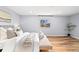 Bright primary bedroom with hardwood flooring, large windows, and calming ambiance at 2484 E 101St Ct, Thornton, CO 80229