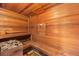 Wooden sauna with built-in benches and a rock heater, perfect for relaxation at 2484 E 101St Ct, Thornton, CO 80229