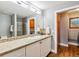 Bright bathroom featuring a vanity with double sinks and a tiled shower at 6269 S Coventry E Ln, Littleton, CO 80123