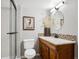 Well-lit bathroom with a glass shower, wooden vanity, and mosaic tile accents at 6269 S Coventry E Ln, Littleton, CO 80123