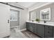 Modern bathroom with double vanity and gray cabinets at 6269 S Coventry E Ln, Littleton, CO 80123