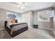 Comfortable bedroom featuring plush carpeting, a ceiling fan, and bright natural light from a window at 6269 S Coventry E Ln, Littleton, CO 80123