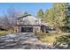 Gray shingle two-story house with a black garage door and landscaped yard at 6269 S Coventry E Ln, Littleton, CO 80123