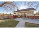 Traditional home with a brick facade, front patio, and meticulously kept lawn at 6269 S Coventry E Ln, Littleton, CO 80123