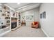 Bright Gathering room featuring a fireplace and built-in bookcases at 6269 S Coventry E Ln, Littleton, CO 80123