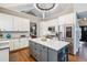 Well-designed kitchen with gray island, marble countertops, stainless steel appliances at 6269 S Coventry E Ln, Littleton, CO 80123