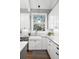 Modern kitchen with white cabinets and farm sink at 6269 S Coventry E Ln, Littleton, CO 80123