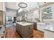 Open kitchen view with island, white cabinetry, stainless appliances, and open concept at 6269 S Coventry E Ln, Littleton, CO 80123