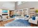 Bright, open living room with fireplace, vaulted ceiling, and sliding doors to the patio at 6269 S Coventry E Ln, Littleton, CO 80123