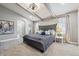 Spacious main bedroom featuring neutral colors, beamed ceilings, and large windows at 6269 S Coventry E Ln, Littleton, CO 80123