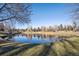 Beautiful pond with lush green surroundings reflecting the sky in a peaceful community at 6269 S Coventry E Ln, Littleton, CO 80123