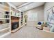 Sitting area with fireplace featuring built-in shelving and cozy seating at 6269 S Coventry E Ln, Littleton, CO 80123