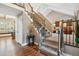 Staircase with gray carpet and iron railing leads to the upper level at 6269 S Coventry E Ln, Littleton, CO 80123