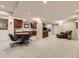 Finished basement area featuring home office setup, built-in shelving, and plush carpet at 6194 E Briarwood Cir, Centennial, CO 80112