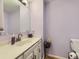 Bathroom featuring neutral paint, white vanity, and decorative flower arrangement at 6194 E Briarwood Cir, Centennial, CO 80112