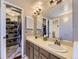 Bathroom featuring a dual vanity, closet and tile flooring at 6194 E Briarwood Cir, Centennial, CO 80112