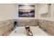 Relaxing tub featuring elegant tile work and a tranquil beach-themed picture at 6194 E Briarwood Cir, Centennial, CO 80112