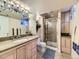 Elegant bathroom featuring vanity, shower, and decorative lighting for a spa-like feel at 6194 E Briarwood Cir, Centennial, CO 80112