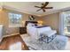 Bright bedroom featuring a ceiling fan, a plush rug, and stylish decor at 6194 E Briarwood Cir, Centennial, CO 80112