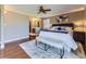 Primary bedroom featuring an ensuite bathroom, plush rug and neutral colors at 6194 E Briarwood Cir, Centennial, CO 80112