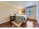 Inviting bedroom featuring warm neutral colors, wood floors, and natural light from large window at 6194 E Briarwood Cir, Centennial, CO 80112