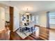 Elegant dining room with modern chandelier, hardwood floors, and access to outdoor patio at 6194 E Briarwood Cir, Centennial, CO 80112