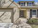 Inviting entrance with brick facade, glass-paneled front door, and manicured landscaping at 6194 E Briarwood Cir, Centennial, CO 80112