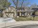 Charming home with a two-car garage, brick accents, and mature trees in a well-manicured lawn at 6194 E Briarwood Cir, Centennial, CO 80112