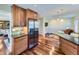 Open concept kitchen with stainless steel refrigerator and view into adjacent dining and living spaces at 6194 E Briarwood Cir, Centennial, CO 80112