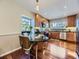 Kitchen with island seating, stainless steel appliances, granite countertops, and natural light at 6194 E Briarwood Cir, Centennial, CO 80112