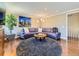 Cozy living room boasts a curved sofa, unique round rug, and stylish decor at 6194 E Briarwood Cir, Centennial, CO 80112