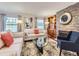 Cozy living room featuring a stone fireplace, built-in shelving, and hardwood floors at 6194 E Briarwood Cir, Centennial, CO 80112