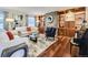 Stylish living room featuring a stone fireplace, built-in shelving, and hardwood floors at 6194 E Briarwood Cir, Centennial, CO 80112