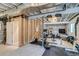 Partially finished basement showcasing an open ceiling, a workout area, and a utility room at 5392 Sanctuary Ave, Firestone, CO 80504