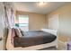 Comfortable bedroom featuring a white bed frame, soft gray bedding, and neutral wall tones at 5392 Sanctuary Ave, Firestone, CO 80504
