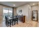 Elegant dining area with wood table, sideboard, and sliding glass door at 5392 Sanctuary Ave, Firestone, CO 80504
