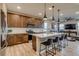 Modern kitchen with stainless appliances, a large island, pendant lighting, and hardwood floors at 5392 Sanctuary Ave, Firestone, CO 80504
