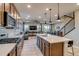 Spacious kitchen with stainless steel appliances, a large island, and an open view to the living area at 5392 Sanctuary Ave, Firestone, CO 80504