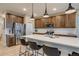 Bright kitchen with stainless appliances, a large island with seating, and sleek countertops at 5392 Sanctuary Ave, Firestone, CO 80504