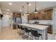 Kitchen featuring stainless appliances, a large island with seating, and wooden cabinets at 5392 Sanctuary Ave, Firestone, CO 80504