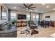 Spacious living room with hardwood floors, large windows, and modern decor at 5392 Sanctuary Ave, Firestone, CO 80504