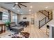 Bright living room with dining area, wood floors, and open floor plan at 5392 Sanctuary Ave, Firestone, CO 80504