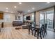 Open-concept living space with hardwood floors, dining table, and comfortable seating at 5392 Sanctuary Ave, Firestone, CO 80504