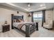 Spacious main bedroom featuring a tray ceiling, large window, and stylish decor at 5392 Sanctuary Ave, Firestone, CO 80504